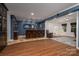 Spacious basement featuring a custom bar, wood flooring, and separate sitting area at 8028 Water View Dr, Belmont, NC 28012