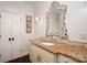 Elegant bathroom with ornate mirror and granite countertops, complemented by classic fixtures at 8028 Water View Dr, Belmont, NC 28012