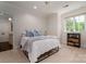 Bedroom showcasing neutral walls, a window letting in natural light and a cozy bed with blue pillows at 8028 Water View Dr, Belmont, NC 28012