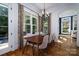 Bright dining area features a modern chandelier, large windows, and backyard access at 8028 Water View Dr, Belmont, NC 28012