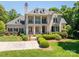 Pristine luxury home showcases meticulously landscaped grounds and a grand, columned facade at 8028 Water View Dr, Belmont, NC 28012
