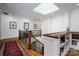 Elegant foyer featuring a skylight, wood floors, and classic staircase with wrought iron railings at 8028 Water View Dr, Belmont, NC 28012