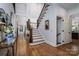 Grand foyer features soaring ceilings, elegant staircase, and gleaming hardwood floors at 8028 Water View Dr, Belmont, NC 28012