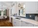 Bright kitchen features an island with sink, stylish backsplash, and stainless steel appliances at 8028 Water View Dr, Belmont, NC 28012