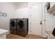 Well-equipped laundry room with modern washer and dryer units and ample storage at 8028 Water View Dr, Belmont, NC 28012