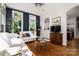 Bright living room featuring rich hardwood floors, white brick accents, and stylish furnishings at 8028 Water View Dr, Belmont, NC 28012
