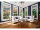 Elegant living room with hardwood floors, natural light from large windows and stylish seating at 8028 Water View Dr, Belmont, NC 28012