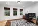 Bright home office with three large windows, a work space with computer and an area rug at 8028 Water View Dr, Belmont, NC 28012