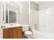 Bathroom features a vanity with a wood cabinet and tub with a shower at 8177 Millwright Ln, Charlotte, NC 28277