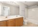 Bathroom features a vanity with double sinks and tub with a shower at 8177 Millwright Ln, Charlotte, NC 28277