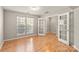 Versatile room with French doors, hardwood floors, and ample natural light, creating a flexible living space at 8177 Millwright Ln, Charlotte, NC 28277