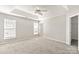 A spacious bedroom with a ceiling fan and a door to a closet or bathroom at 8177 Millwright Ln, Charlotte, NC 28277