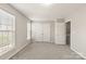 Bright bedroom with large windows, neutral carpet, and a closet at 8177 Millwright Ln, Charlotte, NC 28277