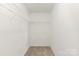 A simple but well-sized closet with wire shelving and neutral carpet at 8177 Millwright Ln, Charlotte, NC 28277
