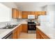 Well-lit kitchen with wooden cabinets, stainless steel appliances, and neutral countertops at 8177 Millwright Ln, Charlotte, NC 28277