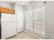 Bright eat-in kitchen with white appliances and natural light from two large windows at 8177 Millwright Ln, Charlotte, NC 28277