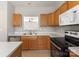 Close-up view of a kitchen with modern appliances, wood cabinets, and a view of another room at 8177 Millwright Ln, Charlotte, NC 28277
