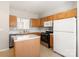 Cozy kitchen with wooden cabinets, modern appliances, an island, and views of other rooms at 8177 Millwright Ln, Charlotte, NC 28277