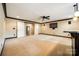 Large basement features a carpeted area, wet bar, neutral walls with dark trim and white doors at 8239 Victoria Lake Dr, Waxhaw, NC 28173