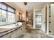 Luxurious bathroom with soaking tub, glass shower, and beautiful tile work at 8239 Victoria Lake Dr, Waxhaw, NC 28173