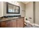 Bathroom with a decorative mirror and dark granite countertop, sink, and tile flooring at 8239 Victoria Lake Dr, Waxhaw, NC 28173