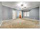 Spacious bedroom with plush carpeting, a ceiling fan and natural light at 8239 Victoria Lake Dr, Waxhaw, NC 28173