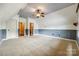 A spacious bonus room with wall trim, dormer windows, a ceiling fan and carpeted floor at 8239 Victoria Lake Dr, Waxhaw, NC 28173