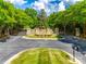 Stone entrance to the neighborhood with wrought iron gates and manicured landscaping at 8239 Victoria Lake Dr, Waxhaw, NC 28173