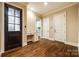 Neutral entryway featuring dark wood floors, white trim, built in desk and lots of natural light at 8239 Victoria Lake Dr, Waxhaw, NC 28173