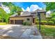 View of the brick home with a three-car garage and basketball hoop in the backyard at 8239 Victoria Lake Dr, Waxhaw, NC 28173