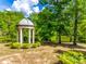 Secluded gazebo overlooking the pond surrounded by trees at 8239 Victoria Lake Dr, Waxhaw, NC 28173