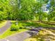 Landscaped grounds with mature trees and walking path at 8239 Victoria Lake Dr, Waxhaw, NC 28173