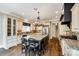 Spacious kitchen features a large granite island with seating, stainless steel appliances, and custom cabinetry at 8239 Victoria Lake Dr, Waxhaw, NC 28173