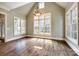 Bright living room with high ceilings, oversized windows, hardwood floors, and chandelier at 8239 Victoria Lake Dr, Waxhaw, NC 28173