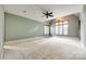 Spacious bedroom with plush carpet, a ceiling fan and a large window to let in lots of natural light at 8239 Victoria Lake Dr, Waxhaw, NC 28173
