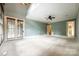 Spacious bedroom with plush carpet, a ceiling fan, french doors and white trim throughout at 8239 Victoria Lake Dr, Waxhaw, NC 28173