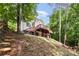 Backyard featuring mature trees and a patio overlooking a wooded view at 9066 Tulagi Ct, Tega Cay, SC 29708