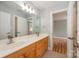 Bathroom featuring dual sinks, a large mirror, and shaker-style cabinets at 9066 Tulagi Ct, Tega Cay, SC 29708