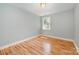 Bedroom featuring hardwood floors, fresh paint, and a window overlooking the beautiful landscape at 9066 Tulagi Ct, Tega Cay, SC 29708