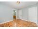 Bedroom featuring hardwood floors, fresh paint, and access to an en suite bathroom at 9066 Tulagi Ct, Tega Cay, SC 29708