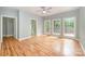 Bright main bedroom featuring three windows, a door to deck, and ensuite bathroom at 9066 Tulagi Ct, Tega Cay, SC 29708