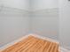 Walk-in closet with hardwood floor and closet organizer at 9066 Tulagi Ct, Tega Cay, SC 29708