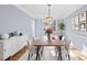 Bright dining room with a modern chandelier, table set for six, and stylish sideboard at 9066 Tulagi Ct, Tega Cay, SC 29708