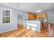 Bright eat-in kitchen with hardwood floors, light-colored walls, and a breakfast bar at 9066 Tulagi Ct, Tega Cay, SC 29708