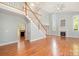 Open concept living area with a staircase, fireplace, high ceilings, and ample natural light from tall windows at 9066 Tulagi Ct, Tega Cay, SC 29708