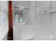 A bathroom with a large mirror, vanity, and vintage fixtures and plenty of storage at 920 Queens Rd, Charlotte, NC 28207