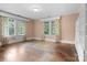 Bright bedroom with large windows, floral curtains, and hardwood floors at 920 Queens Rd, Charlotte, NC 28207