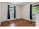 Bedroom with hardwood floors, blue curtains and bright light from the windows at 920 Queens Rd, Charlotte, NC 28207