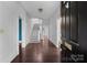 Bright foyer featuring hardwood floors, staircase, and view into other rooms at 920 Queens Rd, Charlotte, NC 28207