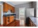 View of kitchen featuring wood cabinets, stainless appliances, hardwood floors and granite counters at 920 Queens Rd, Charlotte, NC 28207